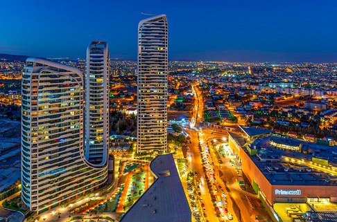 Aerial view of Gaziantep at night with high-rise towers and city lights